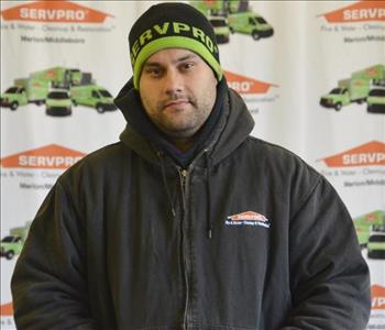 Male standing in front of SERVPRO backdrop